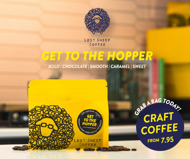 Image of a yellow bag of coffee beans sitting on a kitchen counter. Text reads, “Lost sheep coffee. Get to the hopper. Bold, chocolate, smooth, caramel, sweet. Grab a bag today! Craft coffee from 7.95 GBP.” Lost Sheep Coffee affiliated with SpookyMrsGreen.com mindful parenting and modern pagan lifestyle blog.
